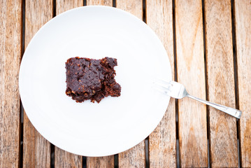 Flat lay of a vegan chocolate brownie with nuts