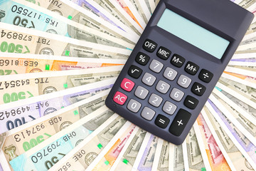Close up view of calculator over  brand new indian 10, 50, 100, 200, 500 and 2000 rupees banknotes. Colorful money pattern.