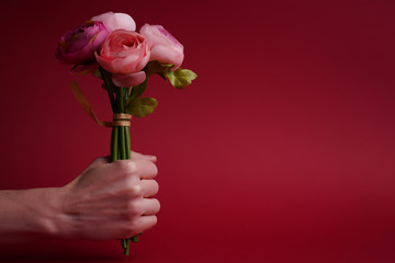 Hand with bouquet of roses. Happy women's Day. Valentine's Day.