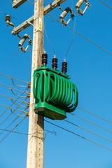 Green energy transformer on concrete pole under blue sky, Airue, Grão Pará, Santa Catarina