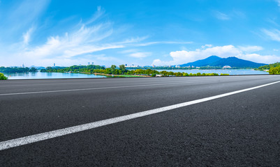 Fototapeta premium Empty asphalt road square and natural landscape under the blue sky