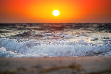 Beautiful summer sunrise with above the stormy sea, seascape