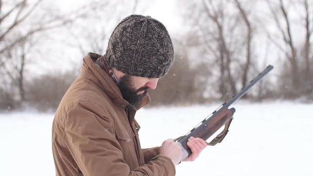 hunter loading the gun before the hunting outdoors. preparation for killing animals.