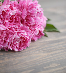 Flowers composition.  Pink peony flowers on wooden background. Mothers day. Flat lay, top view.