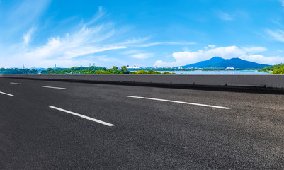 Fototapeta premium Empty asphalt road square and natural landscape under the blue sky
