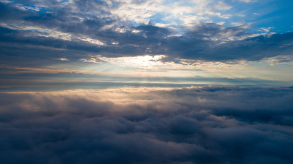 Aerial view of the heaven. Heavenly sunrise above the clouds. View from the window in the plane. Walking in the cloud.