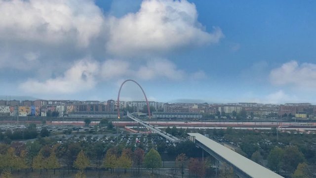 Cinemagraph - Clouds floating over the industrial urban landscape on autumn day. Lingotto pedestrian bridge, Turin, Italy. Il ponte pedonale del Lingotto, Torino
