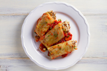 Stuffed cabbage leaves with meat, rice and vegetables. Chou farci, dolma, sarma, sarmale, golubtsy or golabki - popular dish in many countries. View from above, top studio shot