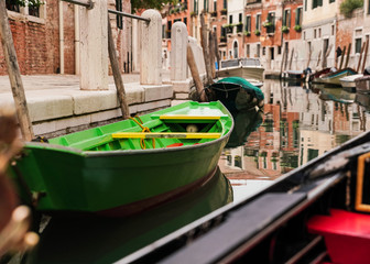 Fototapeta na wymiar Green Boat on Venice Italy Canal 