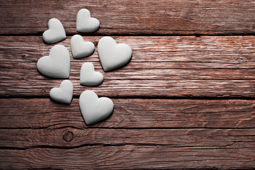 Obraz na płótnie Canvas Valentine's Day , white hearts on old wooden floor