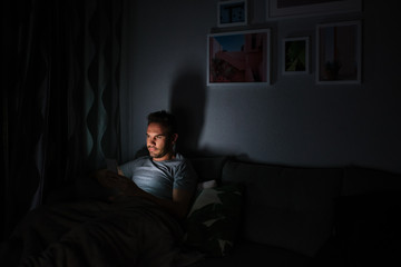 Fototapeta premium Man in pajamas with a mobile phone