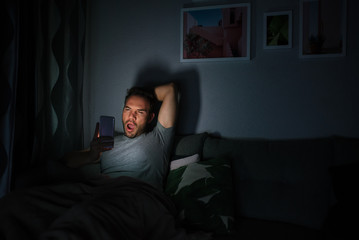 Fototapeta premium Man in pajamas with a mobile phone