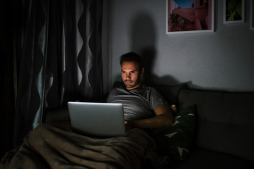 Man in pajamas with a computer