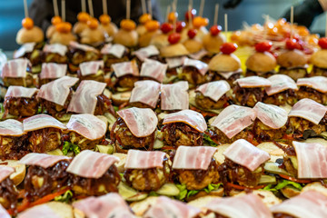Closeup View of Sliced Bread Spread on the Table with Ingredients on them for Small Burgers