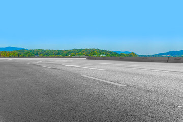 Fototapeta premium Empty asphalt road and natural landscape under the blue sky
