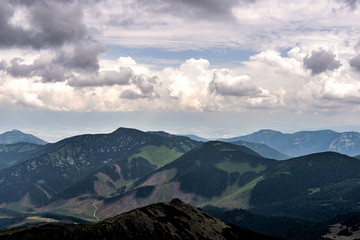 Obraz premium Summer mountains green grass and cloudy sky landscape.