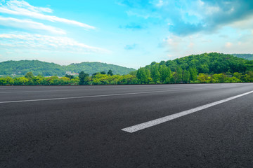 Fototapeta premium Empty asphalt road and natural landscape under the blue sky