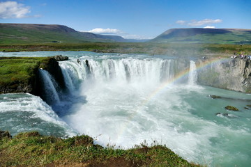Fototapeta na wymiar Godafoss waterfall on a glorious sunny day with rainbow, Iceland
