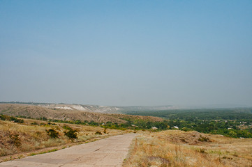 The road in nature and ecological landscape. Ecology and environmental protection. Ecology of transport. Pollution by emissions from cars. Green energy. Soft focus.