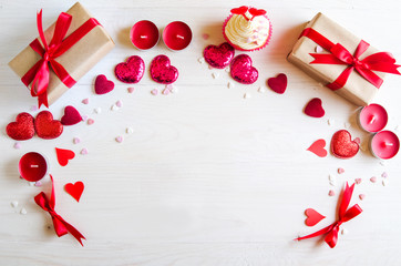 Valentines day wooden background with red heart, gifts and candles. Gifts for Valentines day. White wooden background