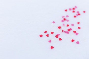 Red felt valentine hearts on the snow white background. Valentine's day concept