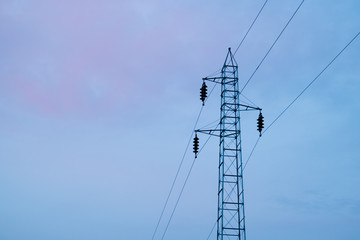 Obraz premium Electric pylon with a power line in the sunset