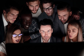 close-up of businessman and business team looking at computer monitor