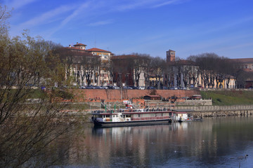 Fototapeta premium fiume po con barca a pavia in italia in europa, po river with boat and historic building in italy, europe