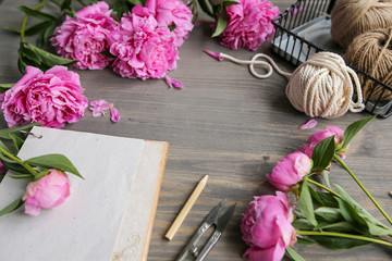 Vintage background, hand made. Pink peony and old scissors, ribbons,  notebook for text. Mothers day.