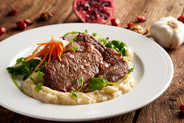Rib-eye steak with sweet potato-herb purée and leaf lettuce