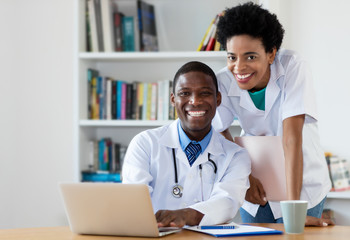African american doctor with nurse looking at camera