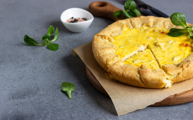 Quiche Lorraine with chicken on grey stone background. Thanksgiving or Christmas chicken homemade quiche with chicken. Traditional French food. 