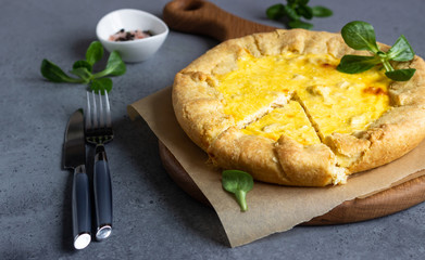 Quiche Lorraine with chicken on grey stone background. Thanksgiving or Christmas chicken homemade quiche with chicken. Traditional French food. 