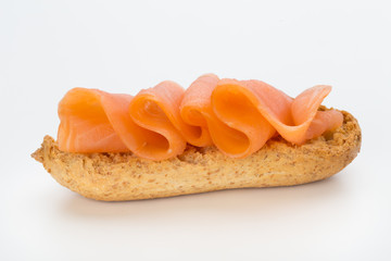 Bread with fresh salmon fillet isolated on white background, top view.