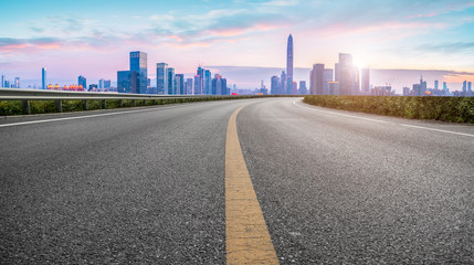 Fototapeta premium Empty asphalt road along modern commercial buildings in China,s cities