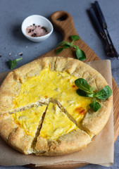 Quiche Lorraine with chicken on grey stone background. Thanksgiving or Christmas chicken homemade quiche with chicken. Traditional French food. 