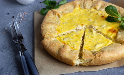 Quiche Lorraine with chicken on grey stone background. Thanksgiving or Christmas chicken homemade quiche with chicken. Traditional French food. 