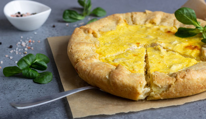 Quiche Lorraine with chicken on grey stone background. Thanksgiving or Christmas chicken homemade quiche with chicken. Traditional French food. 