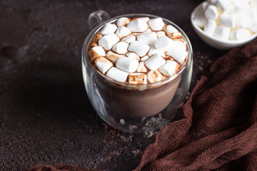 Glass cup of hot chocolate or cocoa drink with marshmallows. Traditional winter or autumn hot drink. Holiday concept, Selective focus.