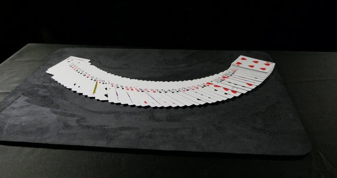 Tracking shot of cards spread evenly on a table