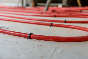Tubes of the underfloor heating system on a styrofoam insulation