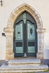 Naklejka premium Tallinn in Estonia, wooden colorful door in the medieval city center, typical house 
