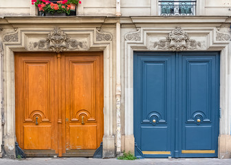 Paris, two wooden doors in a typical street, ancient buildings