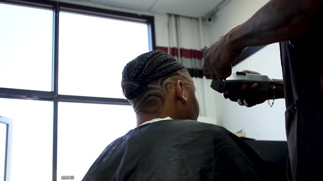 Woman getting a haircut in a barber shop