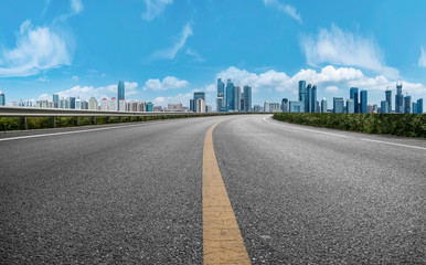 Empty asphalt road along modern commercial buildings in China,s cities