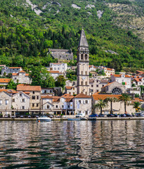 Fototapeta na wymiar Beautiful view of the embankment of Perast, on the coast of Kotor Bay in Montenegro. September 22, 2018