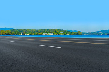 Fototapeta premium Empty asphalt road and natural landscape under the blue sky