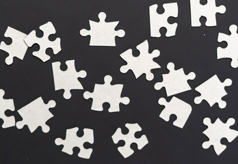 white unfinished puzzle on dark background unsolve uncomplete b