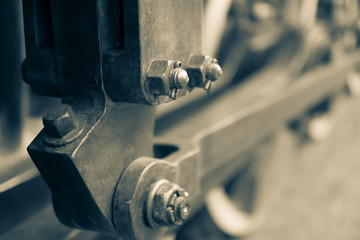 BW image of the details of the old Steam locomotive with cranks and wheels