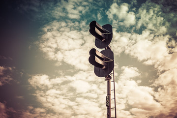 filtered photo of railway semaphore on blue sky background. Railway Traffic light